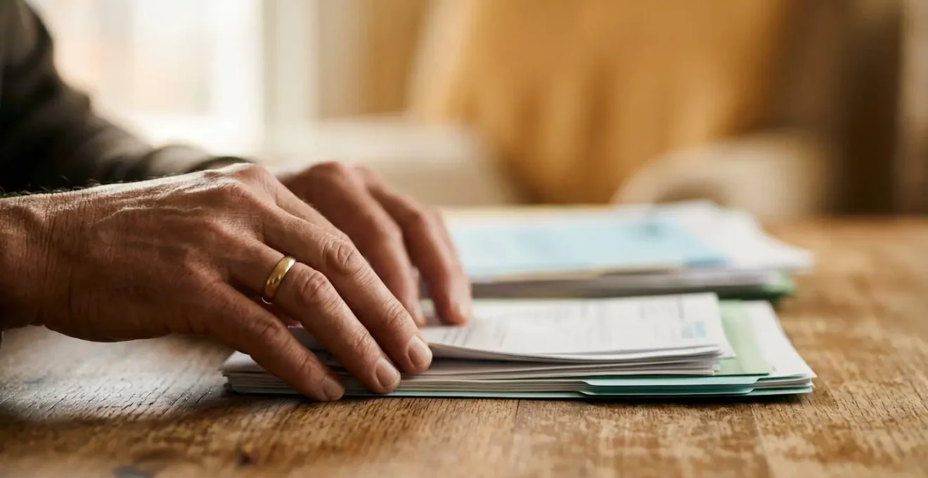 Close-up view of hands organizing financial documents during debt moratorium planning period