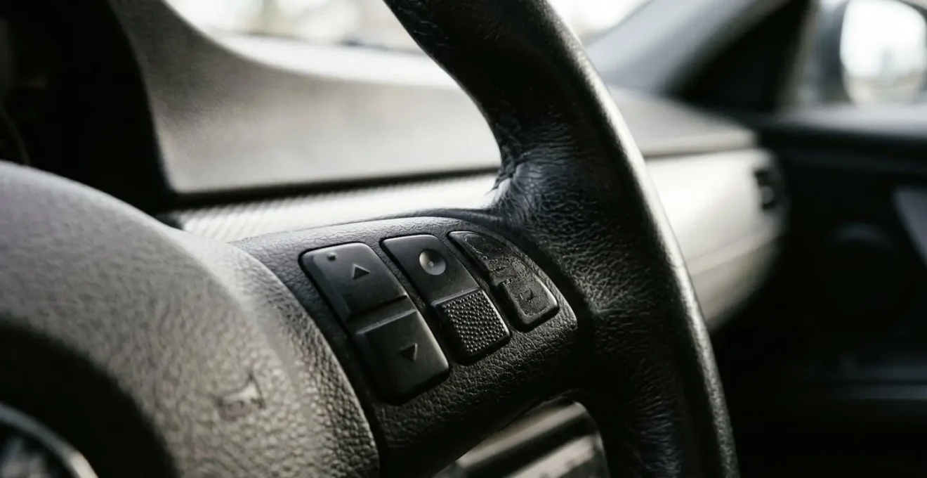 Close-up of car interior showing steering wheel with security concept emphasizing invisible electronic protection layer