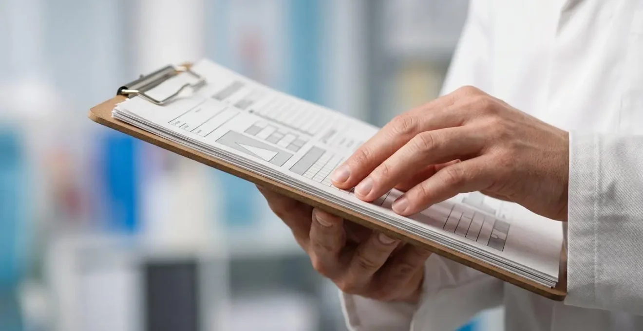 Close-up of a medical professional's hands reviewing surgical procedure notes in a clinical setting with natural lighting