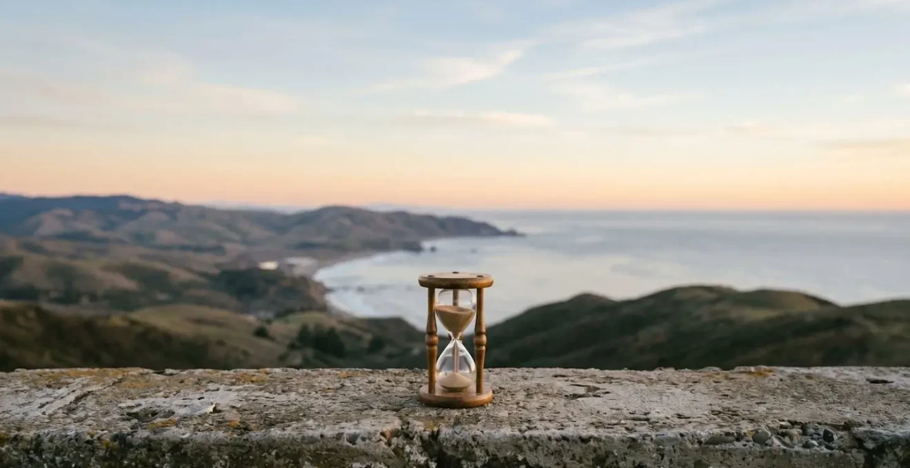 A minimalist photograph of a solitary hourglass, symbolizing the passage of time and the urgency of financial planning decisions.